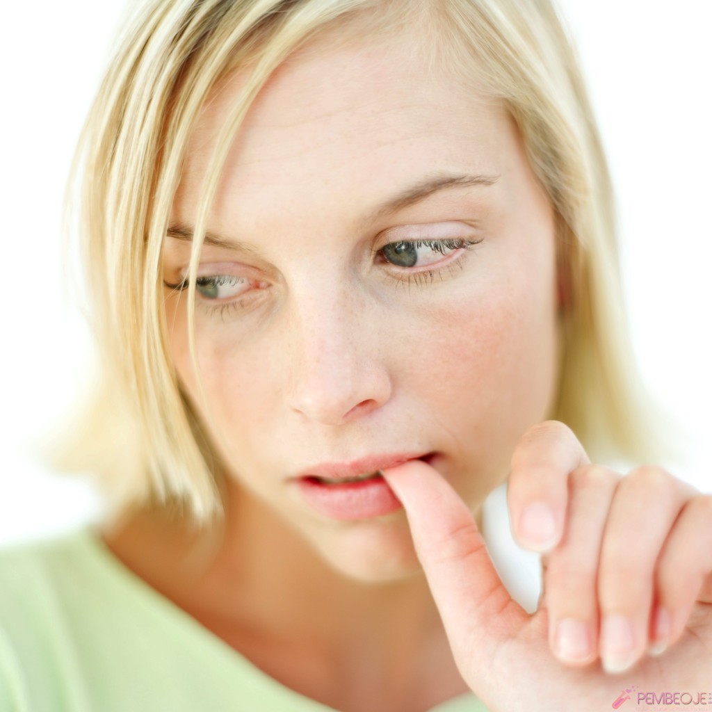 Young Woman Biting Her Finger Nail
